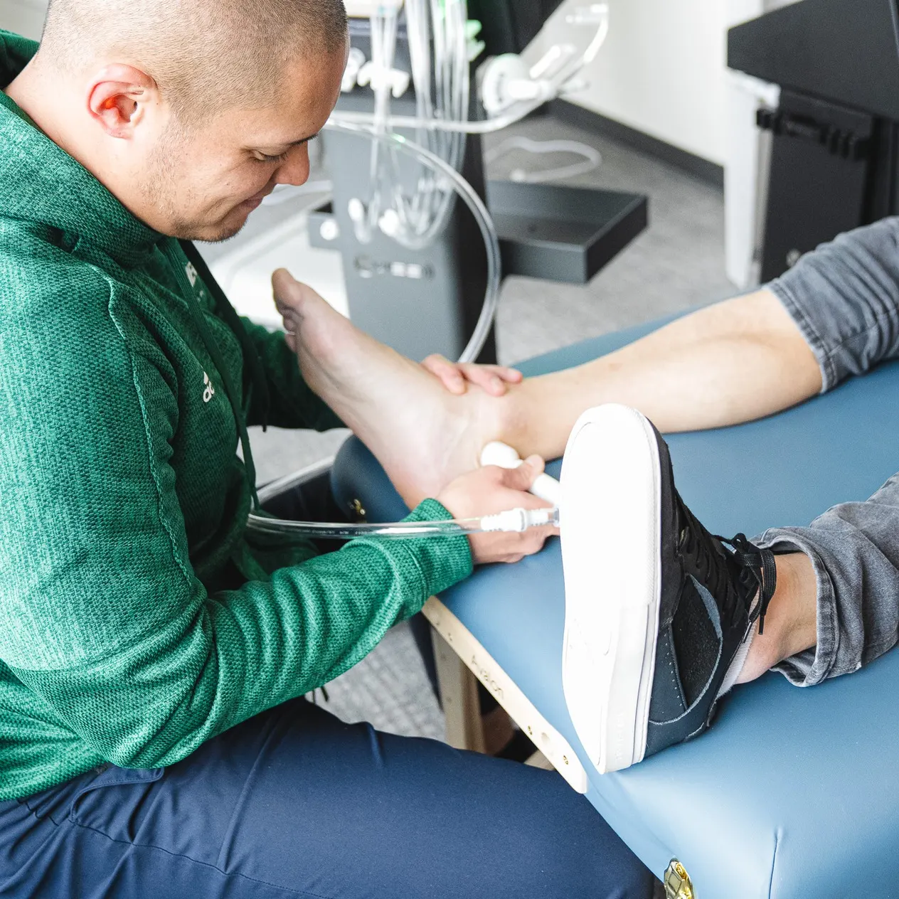 Hecker Sports Medicine clinician performing non-invasive foot and ankle treatment
